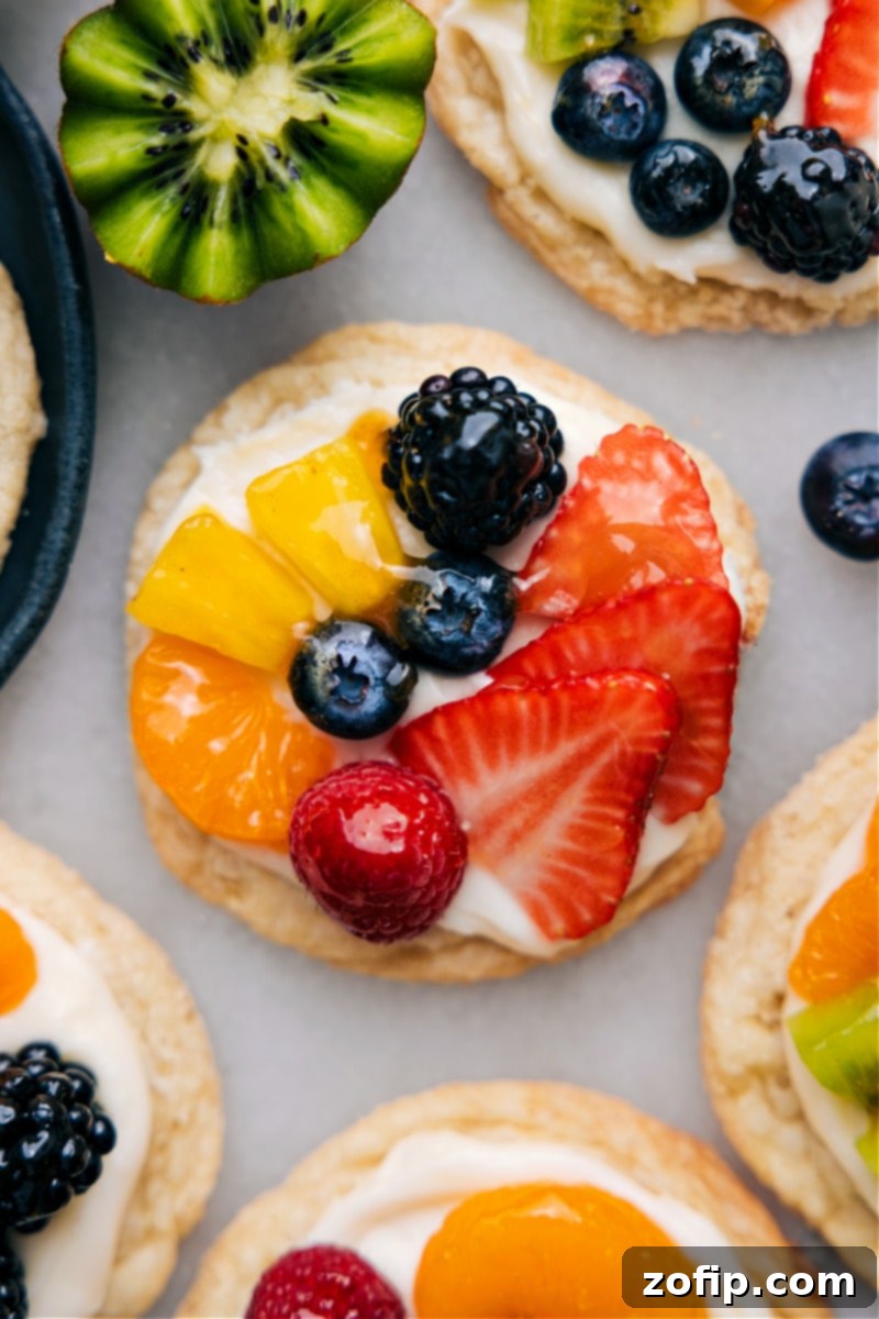 Close-up overhead shot of a single, perfectly crafted Sugar Cookie Fruit Pizza, ready to be enjoyed, showcasing glossy glazed fruits on creamy frosting.
