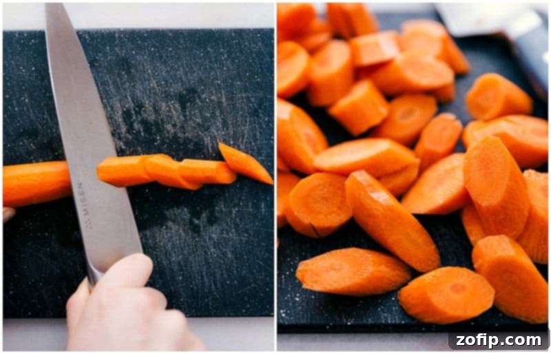 Fresh carrots being expertly chopped on a cutting board, preparing them for the roasting process in our favorite roasted carrot salad.