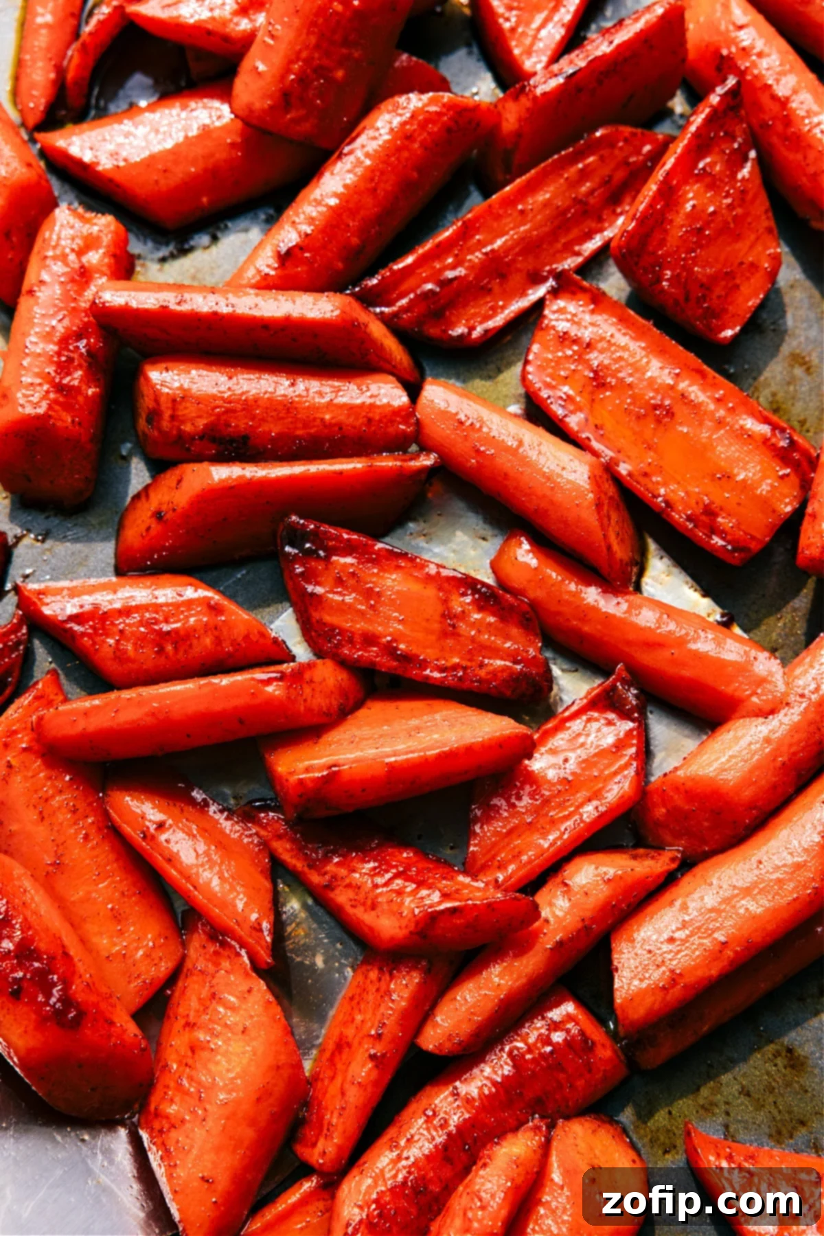 The Best Brown Sugar Roasted Carrots: A Sweet & Savory Side Golden brown sugar roasted carrots with caramelized edges on a baking sheet, ready to be served.