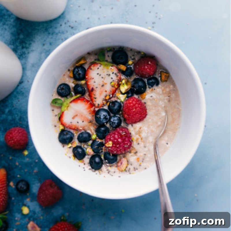 Hot oats with a vibrant mix of fresh blueberries, strawberries, and raspberries.