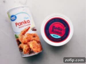 Irresistible Chicken Meatballs 4 Closeup of fresh basil pesto in a small wooden bowl, garnished with basil leaves, ready to be served with pasta or meatballs.