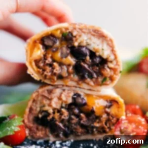 Finished Beef Burrito Recipe cut in half, showcasing the layers of filling.