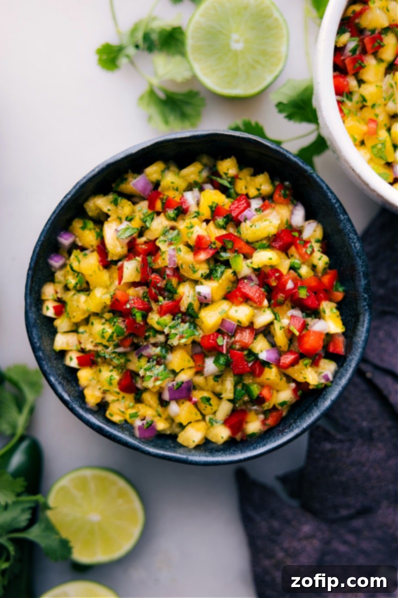 Overhead close-up image of a vibrant bowl of freshly made Pineapple Salsa, ready to be served.
