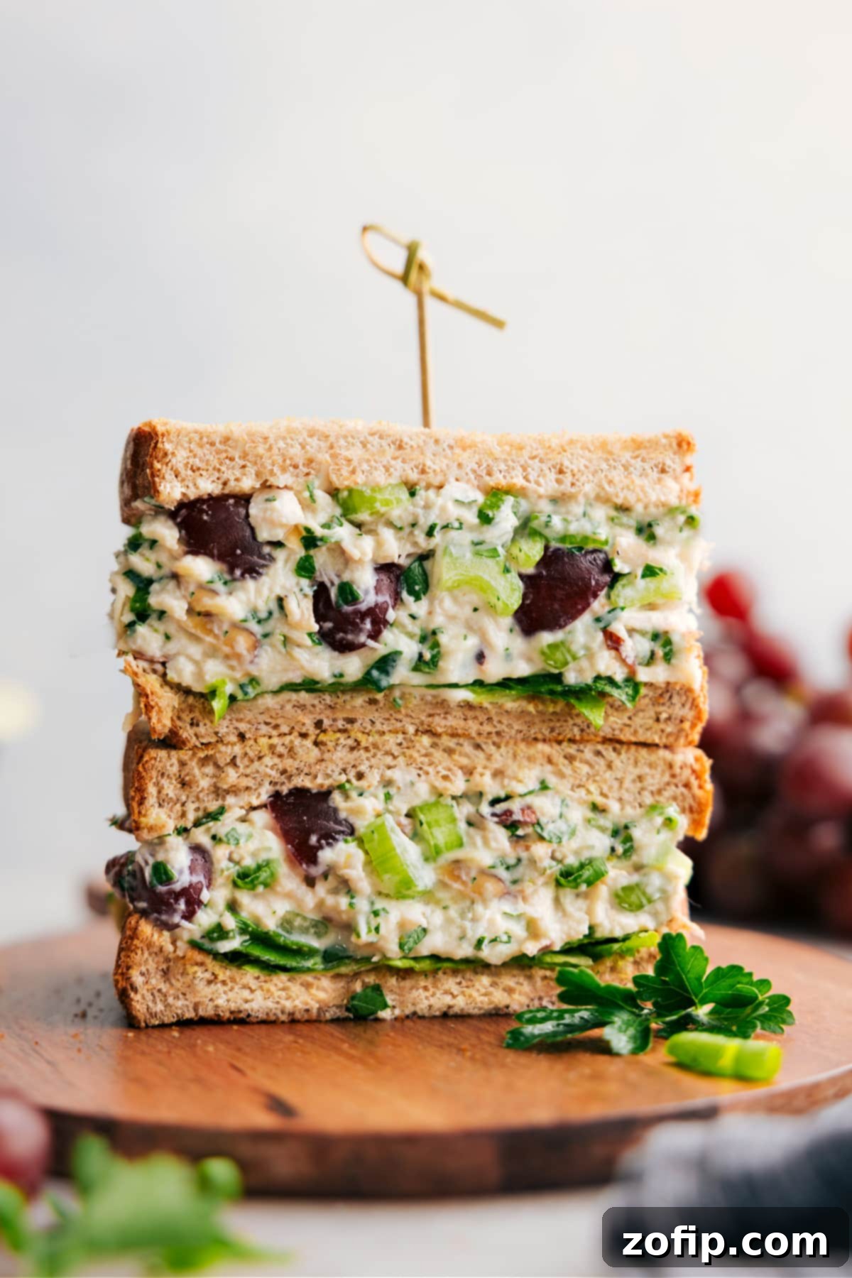 A delicious healthy chicken salad sandwich, with the salad layered between slices of bread, showcasing the fresh ingredients.