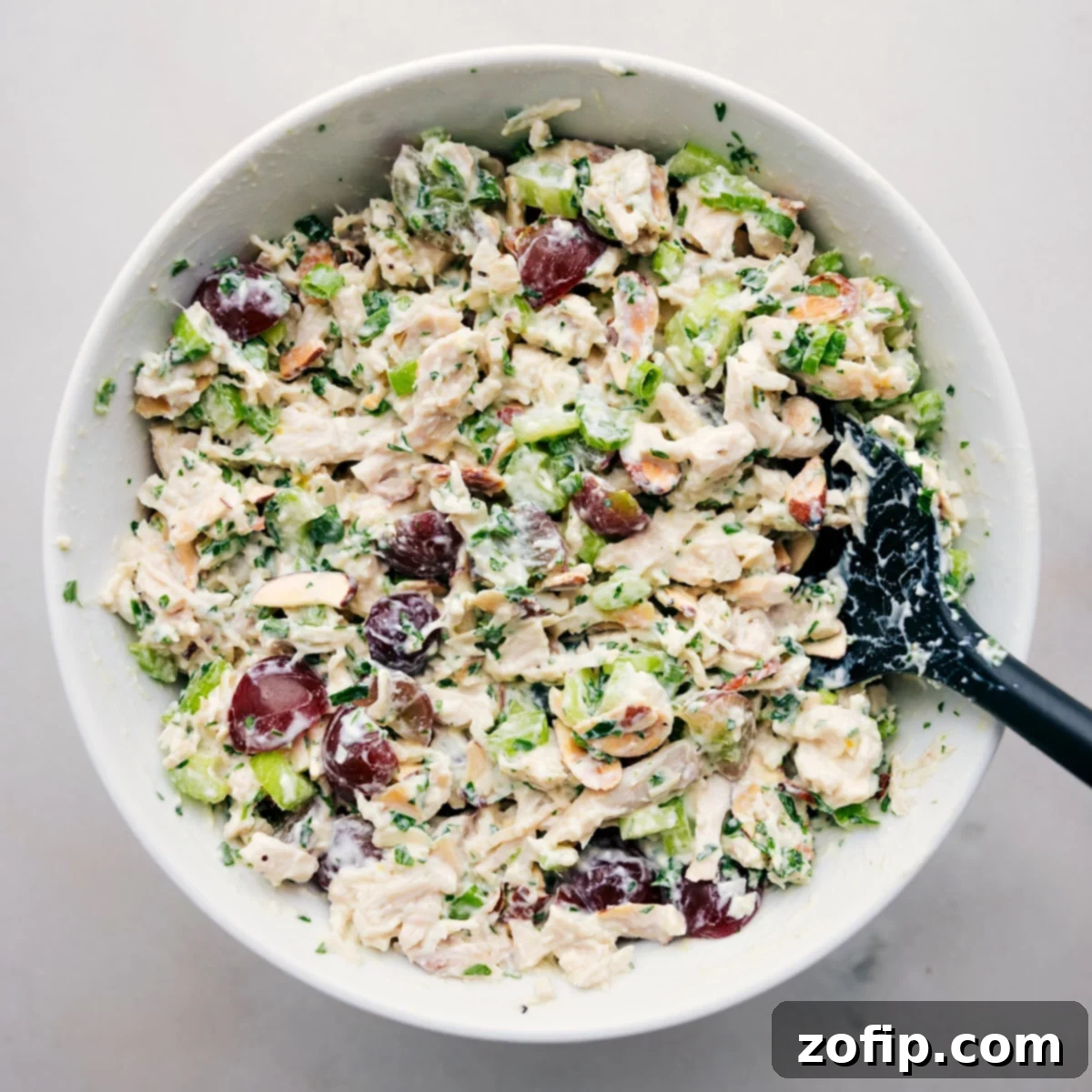 A bowl of delicious healthy chicken salad, garnished with fresh herbs and ready to be served and enjoyed.