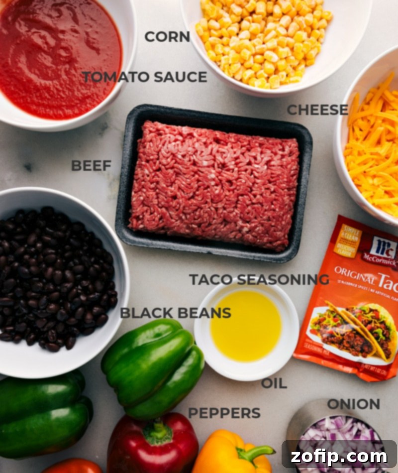 A vibrant flat lay image showcasing all the fresh and colorful ingredients required to make Bell Pepper Nachos, including various bell peppers, lean ground beef, shredded cheese, and essential seasonings.