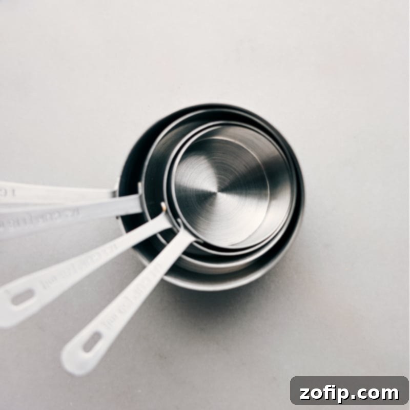 Close-up image of a set of dry measuring cups and spoons, ready for use in a kitchen for precise baking