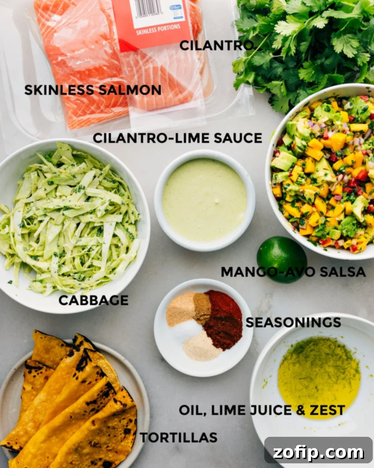 All the fresh ingredients for the salmon tacos prepped and laid out for easy assembly, highlighting the freshness and vibrant colors.