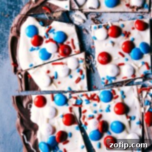 A festive image of the finished 4th of July Bark cut into pieces, showcasing the red, white, and blue toppings, ready to serve and enjoy.