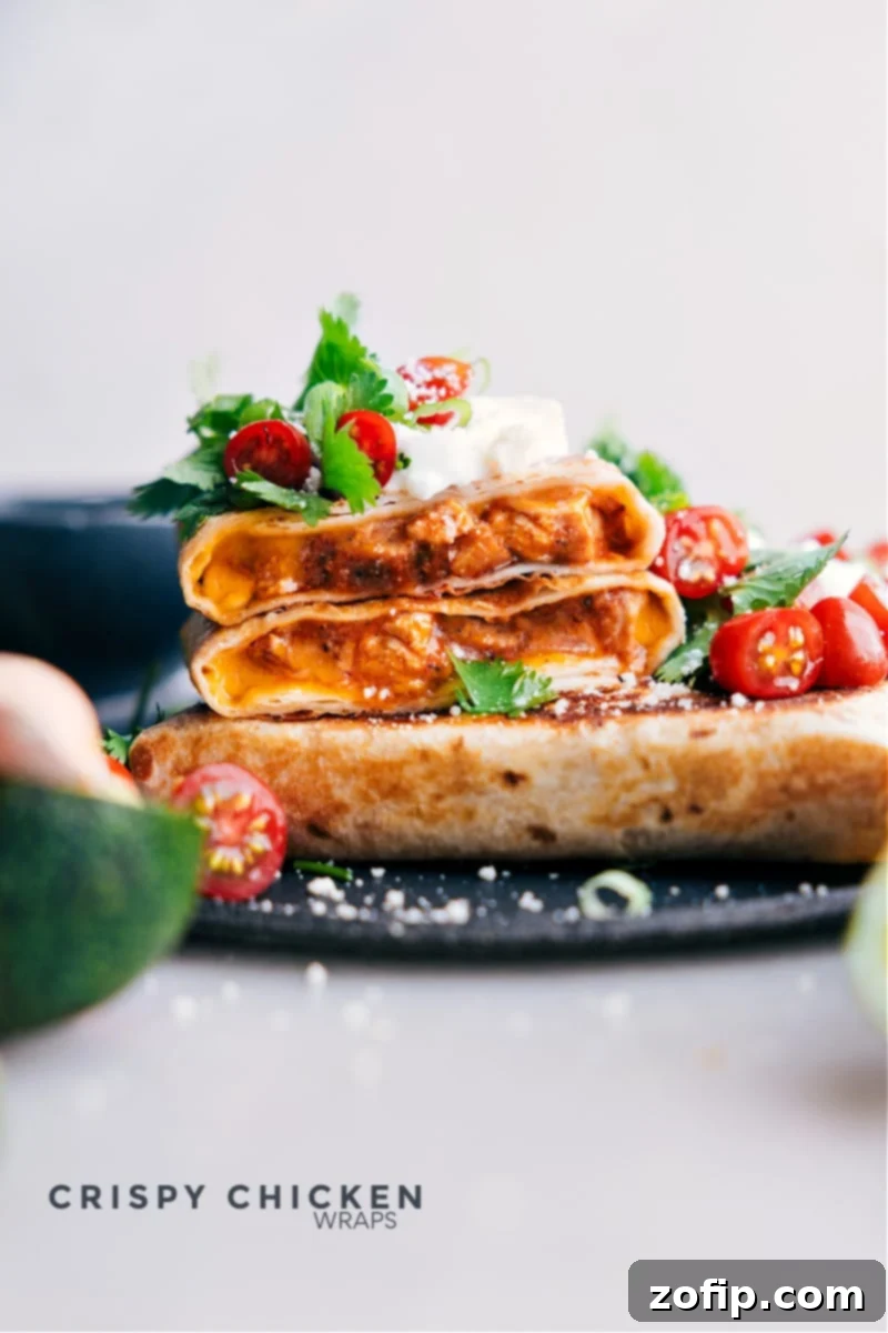 Golden-brown crispy chicken wraps on a serving platter, ready to eat