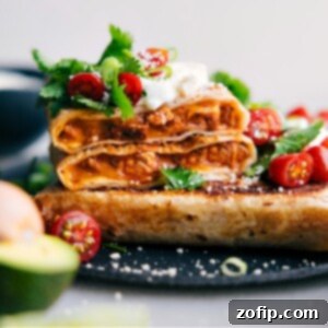 A beautifully presented Crispy Chicken Wrap, cut in half to show the delicious filling inside