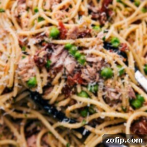 Wholesome Tuna Pasta Bowl 2 A bowl of healthy tuna pasta, freshly prepared and topped with grated cheese, inviting a savory and nutritious meal experience.