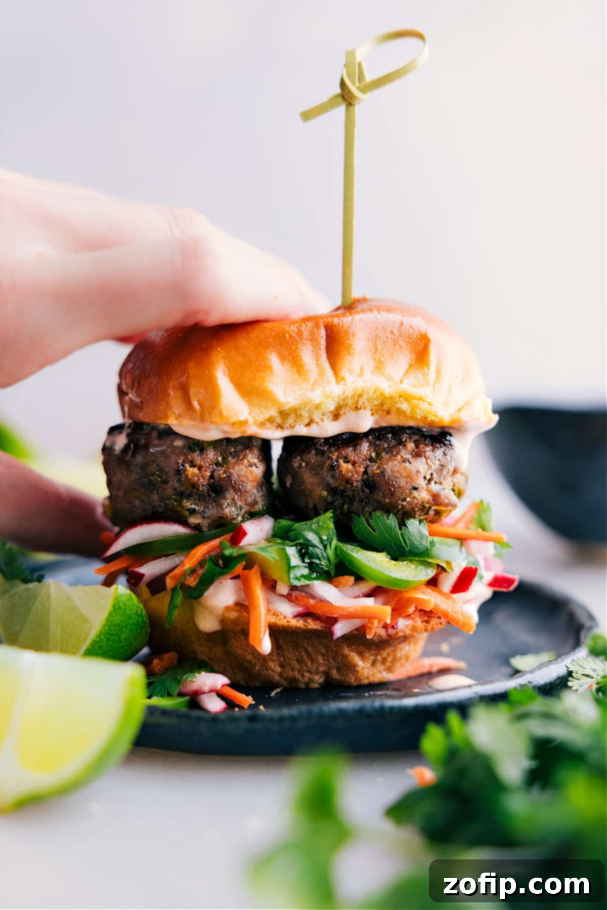 Scrumptious Fully-Assembled Slider, A Symphony of Ingredients Ready to Delight Completed slider, a visual feast showcasing layers of delicious ingredients including the banh mi meatballs, ready to be relished.