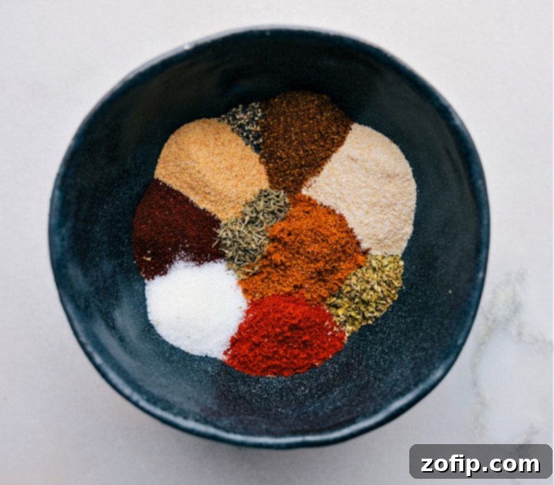 This Blackening Seasoning recipe creates a versatile, smoky, and spicy blend perfect for forming a flavorful crust on grilled or pan-fried dishes. Recipe via chelseasmessyapron #spice #seasonings #quick #easy #simple #grilling #blackening #seasoning A selection of individual spices including paprika, cayenne, thyme, and oregano, neatly arranged.