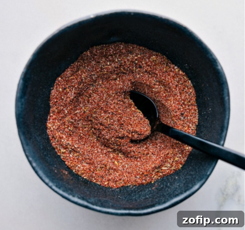 Blackening Seasoning recipe! Easily homemade, it combines everyday spices and can be stored for future use, bringing a robust flavor to meats, fish, and vegetables. Recipe via chelseasmessyapron #spice #seasonings #quick #easy #simple #grilling #blackening #seasoning A bowl filled with the combined blackening spice mix, perfectly blended and ready for use.
