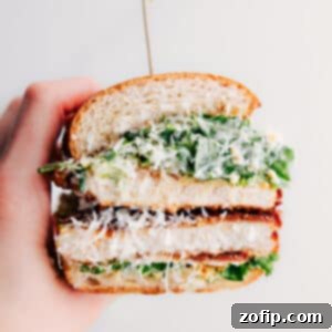 Crispy Chicken Caesar Sandwich on a cutting board, ready to be served.