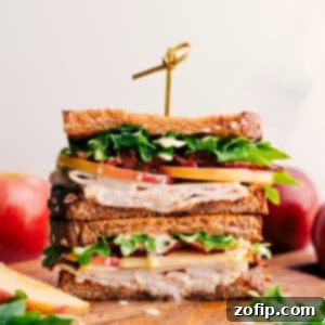 Close-up of a delicious Turkey Sandwich with melted Gouda, bacon, and apple