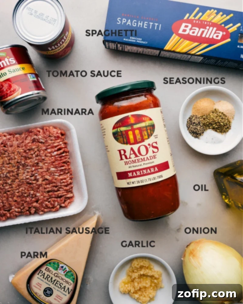 Collection of fresh ingredients for Instant Pot Spaghetti, including Italian sausage, marinara, tomatoes, onions, garlic, and spices