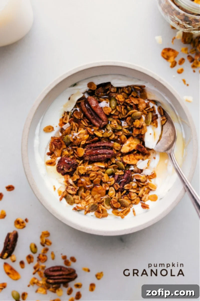 Overhead image of freshly baked Pumpkin Granola with whole pecans and almonds
