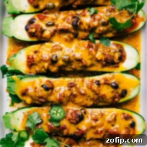 Zucchini Fiesta Bake 2 Finished mexican zucchini boats with melted cheese and fresh herbs on top, a hearty and healthy meal.