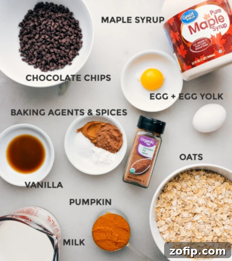 A collection of fresh, high-quality ingredients for Pumpkin Baked Oatmeal, meticulously arranged on a rustic wooden surface, ready for mixing.