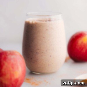 Wholesome Apple Protein Shake 3 A tall glass of Apple Pie Protein Smoothie with a cinnamon sprinkle.