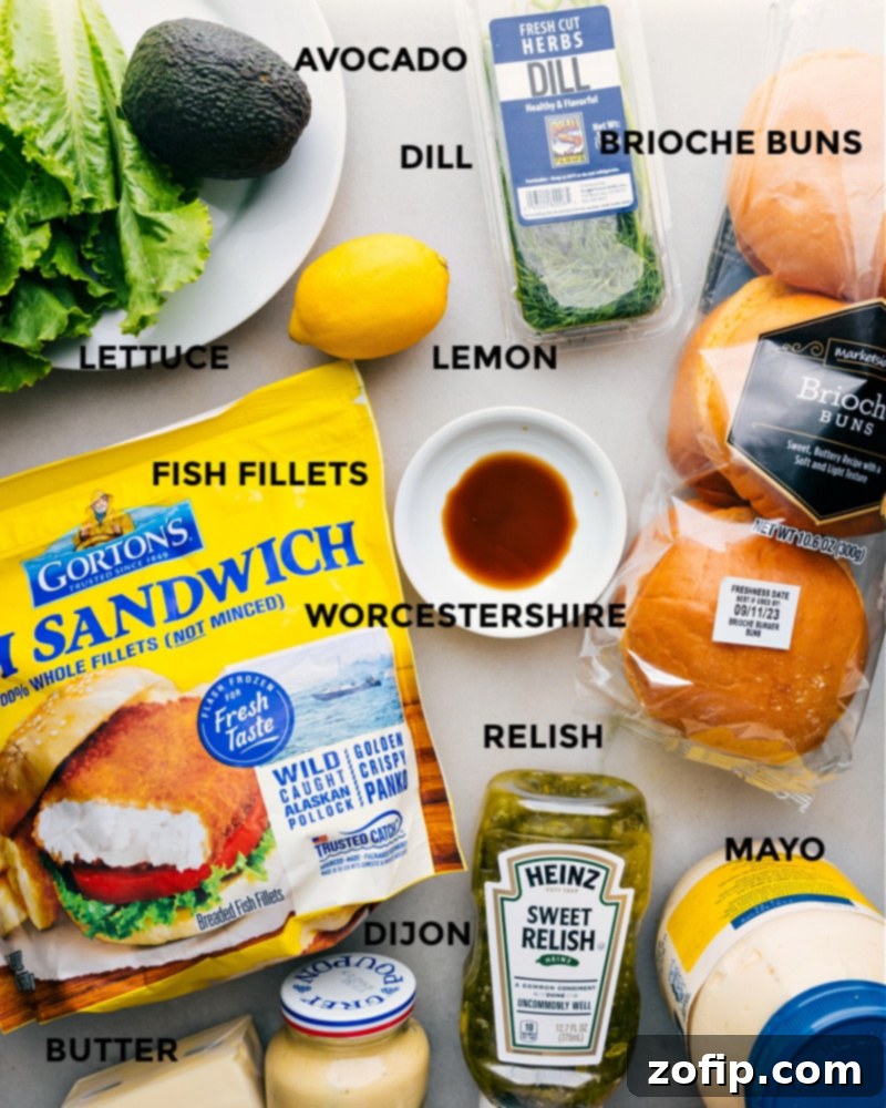 All ingredients for the quick crispy fish sandwich laid out: brioche buns, fish fillets, avocado, lettuce, and sauce ingredients.
