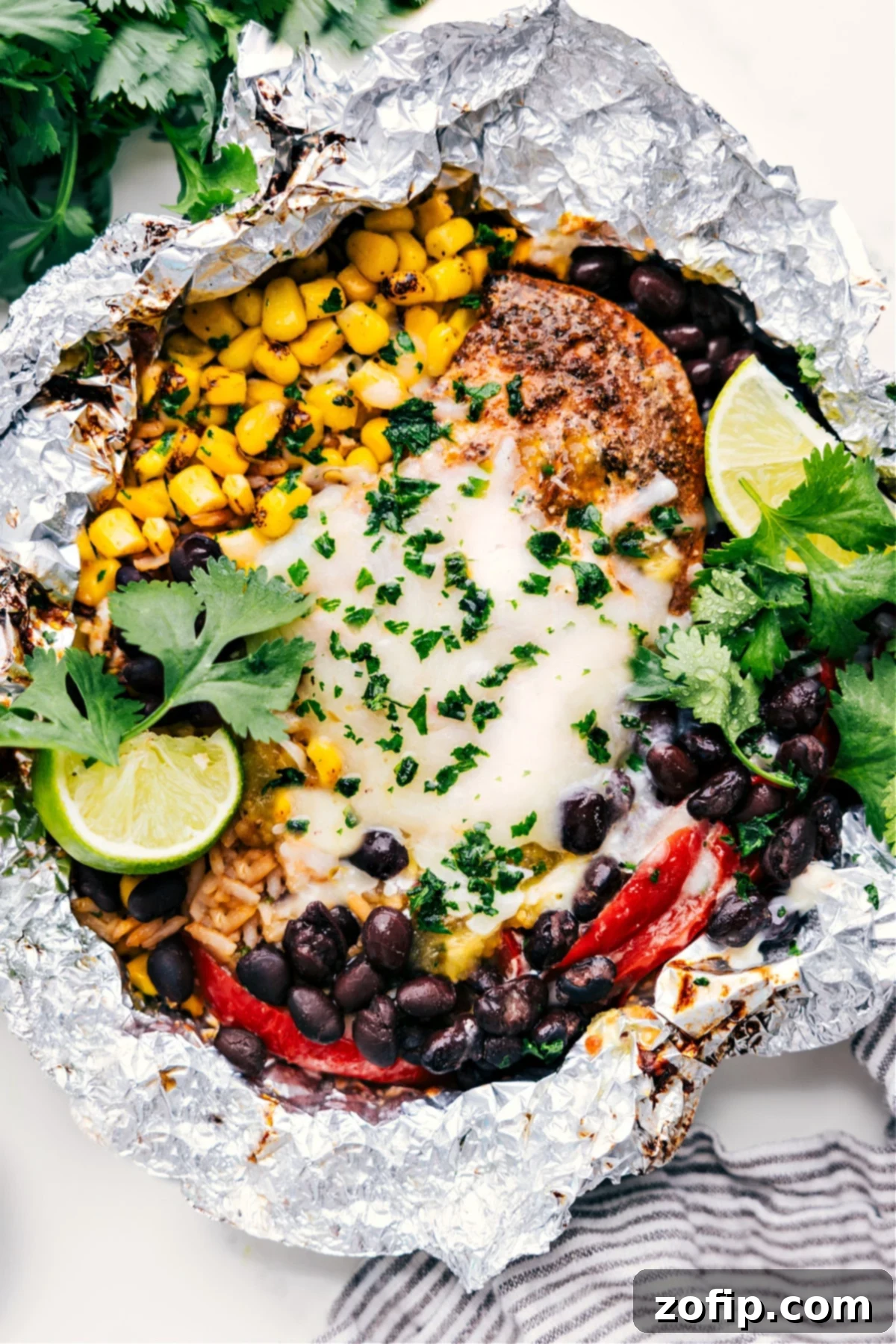 Chicken Rice Foil Packs just out of the oven, topped with melted cheese and ready to eat.