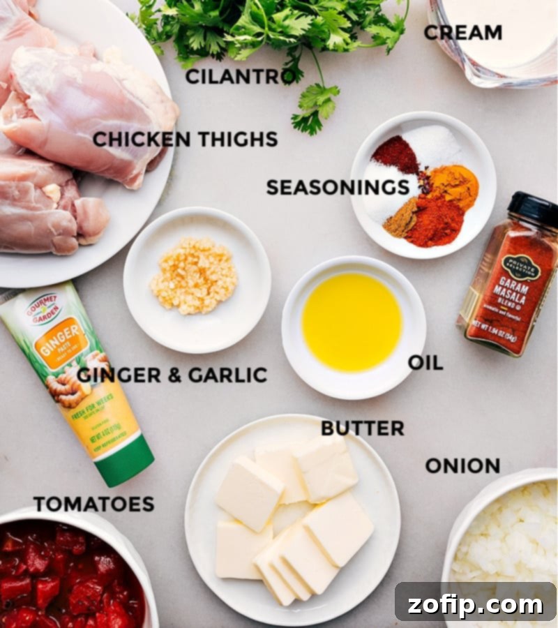 A meticulously arranged array of fresh ingredients laid out for the Instant Pot butter chicken recipe, featuring vibrant spices, tender chicken thighs, canned tomatoes, and rich heavy cream, all ready for cooking.