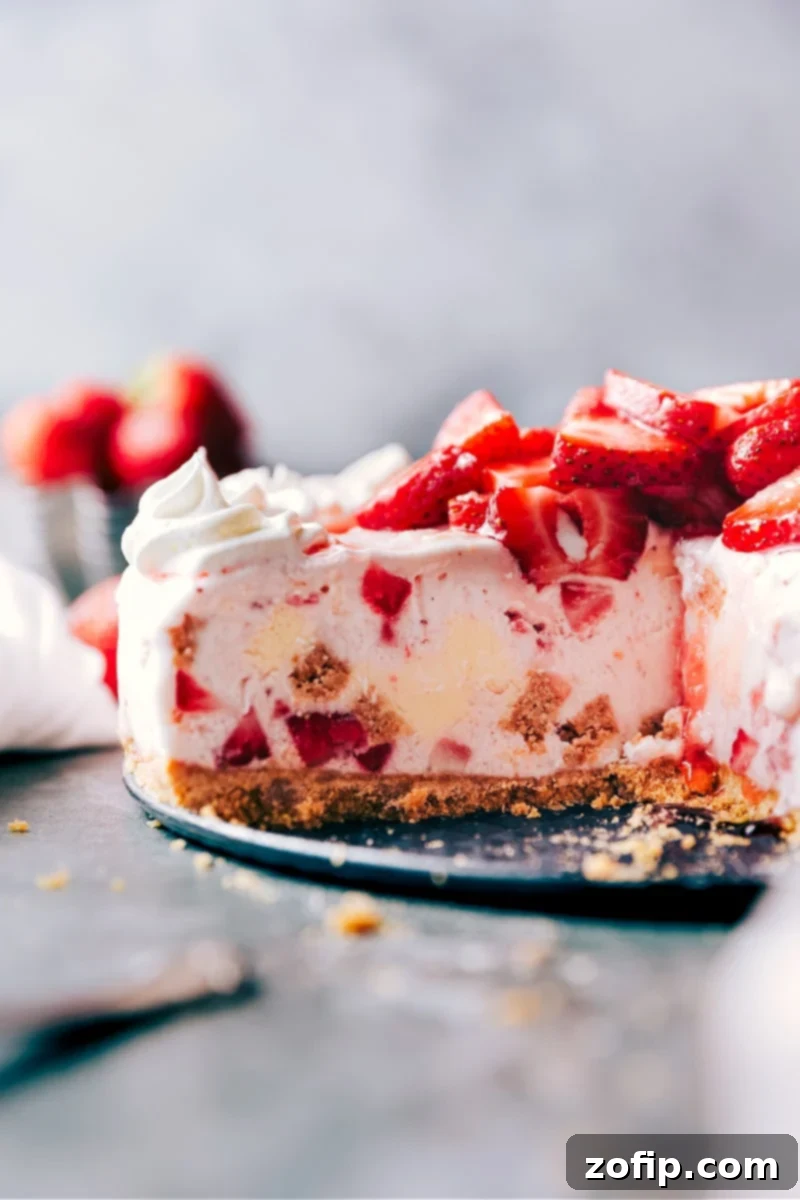 Strawberry Cheesecake Ice Cream Cake: Easy, No-Bake Dessert with Graham Cracker Crust Delicious Strawberry Cheesecake Ice Cream Cake on a serving plate