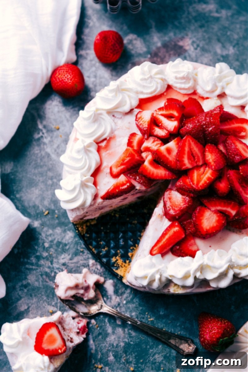 The Ultimate Strawberry Cheesecake Ice Cream Cake, Ready to Serve! Finished Strawberry Cheesecake Ice Cream Cake topped with fresh strawberries
