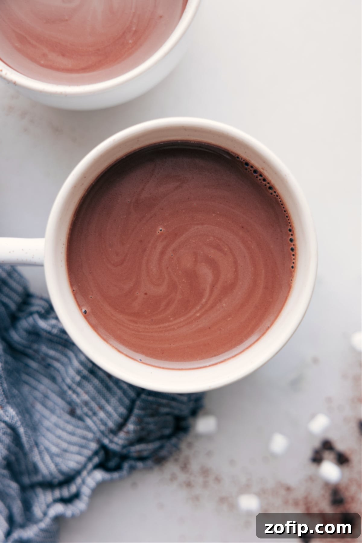 A cup of steaming, swirling hot chocolate, perfectly prepared and ready for enjoyment, inviting warmth and comfort.