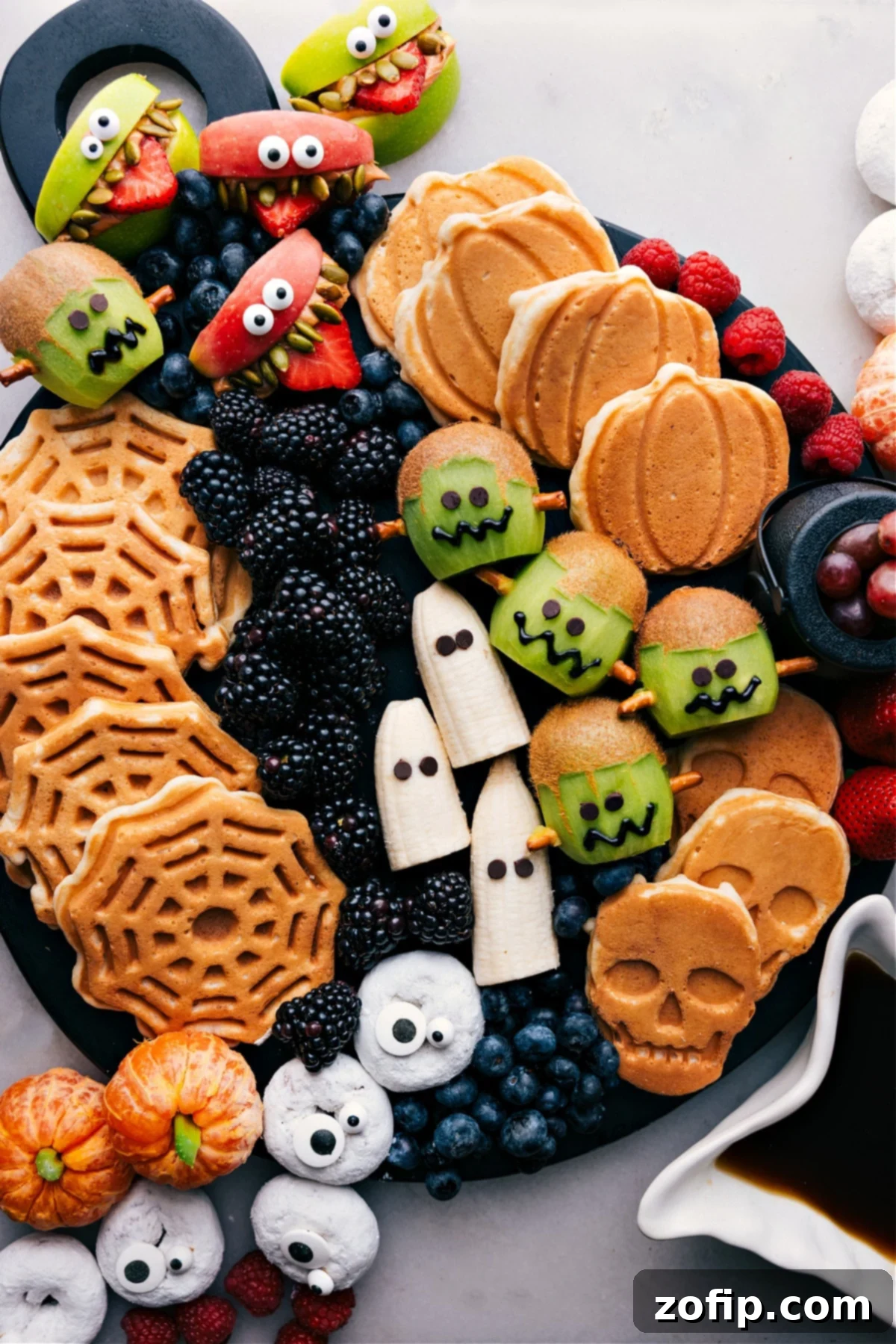 A vibrant display board showcasing a variety of creative and spooky Halloween breakfast ideas, including Frankenstein kiwi, monster donuts, and ghostly bananas.