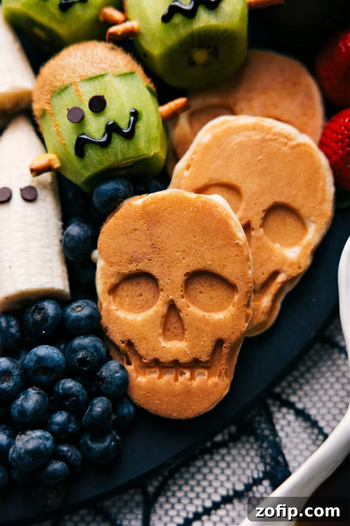 Delicious skull-shaped pancakes, freshly cooked and perfectly golden, ready to be served as a spooky Halloween breakfast.