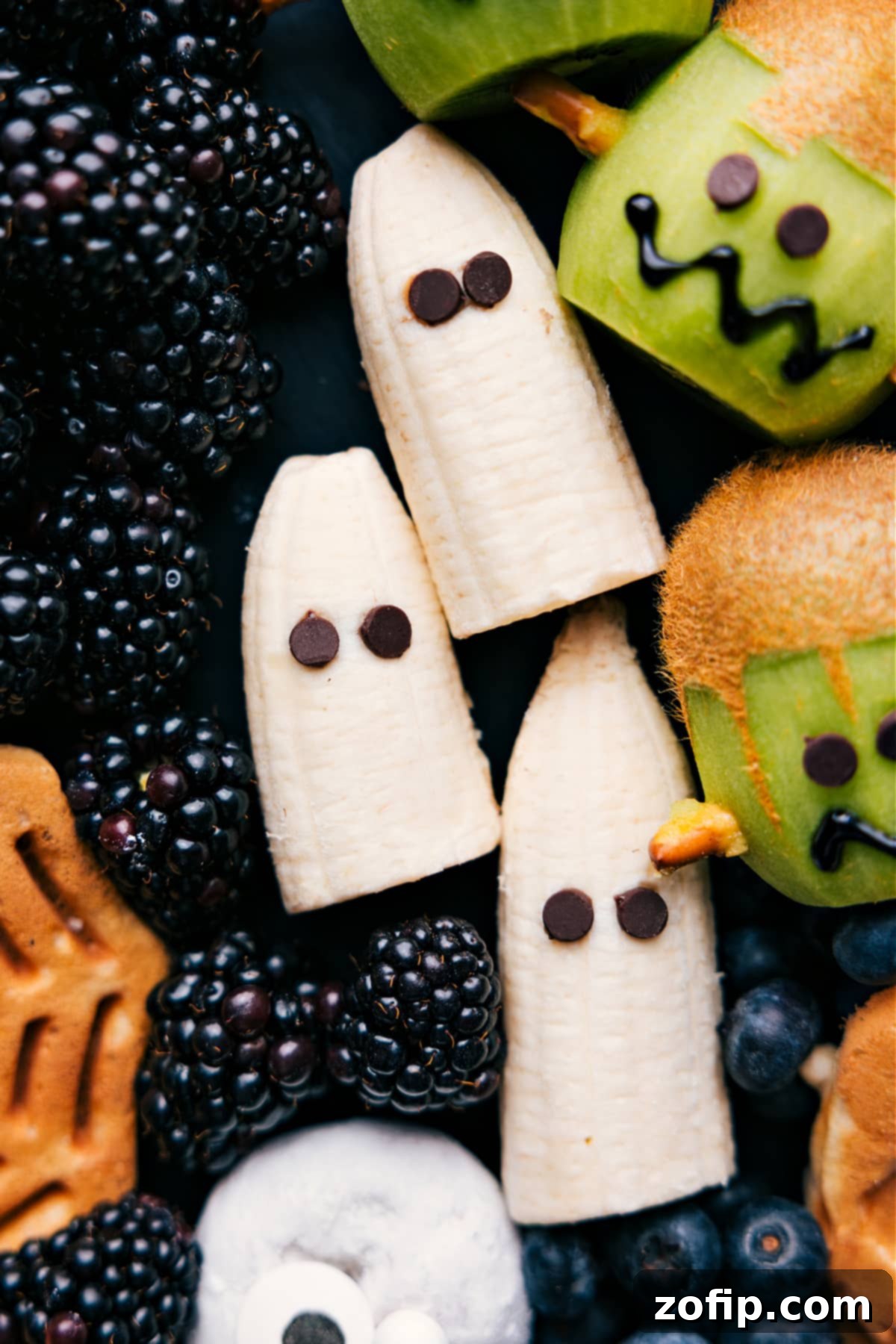 A creative Halloween breakfast idea featuring a banana ghost with chocolate chip eyes, presented on a decorative tray.