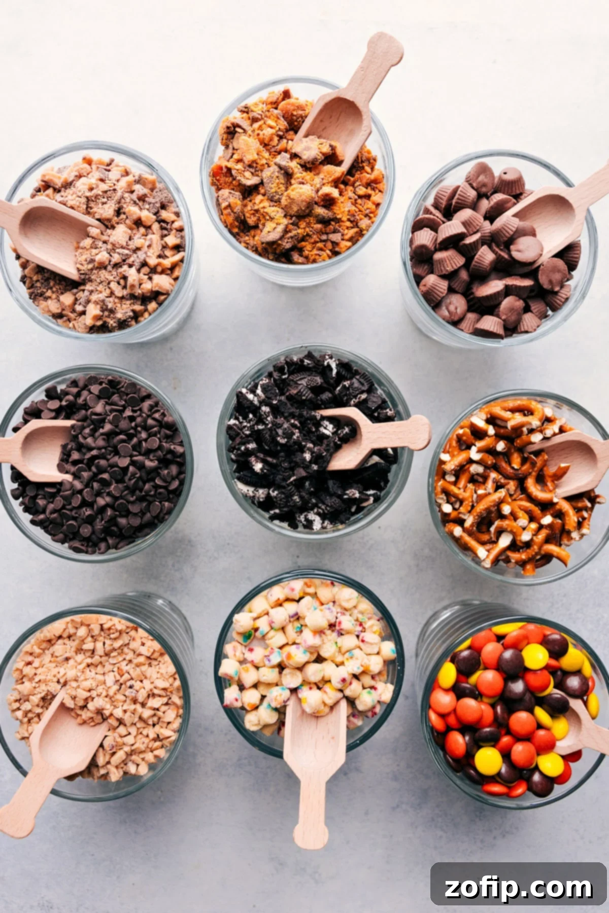 Bowls filled with a diverse selection of sweet, savory, and healthy mix-ins for a customizable Popcorn Bar.
