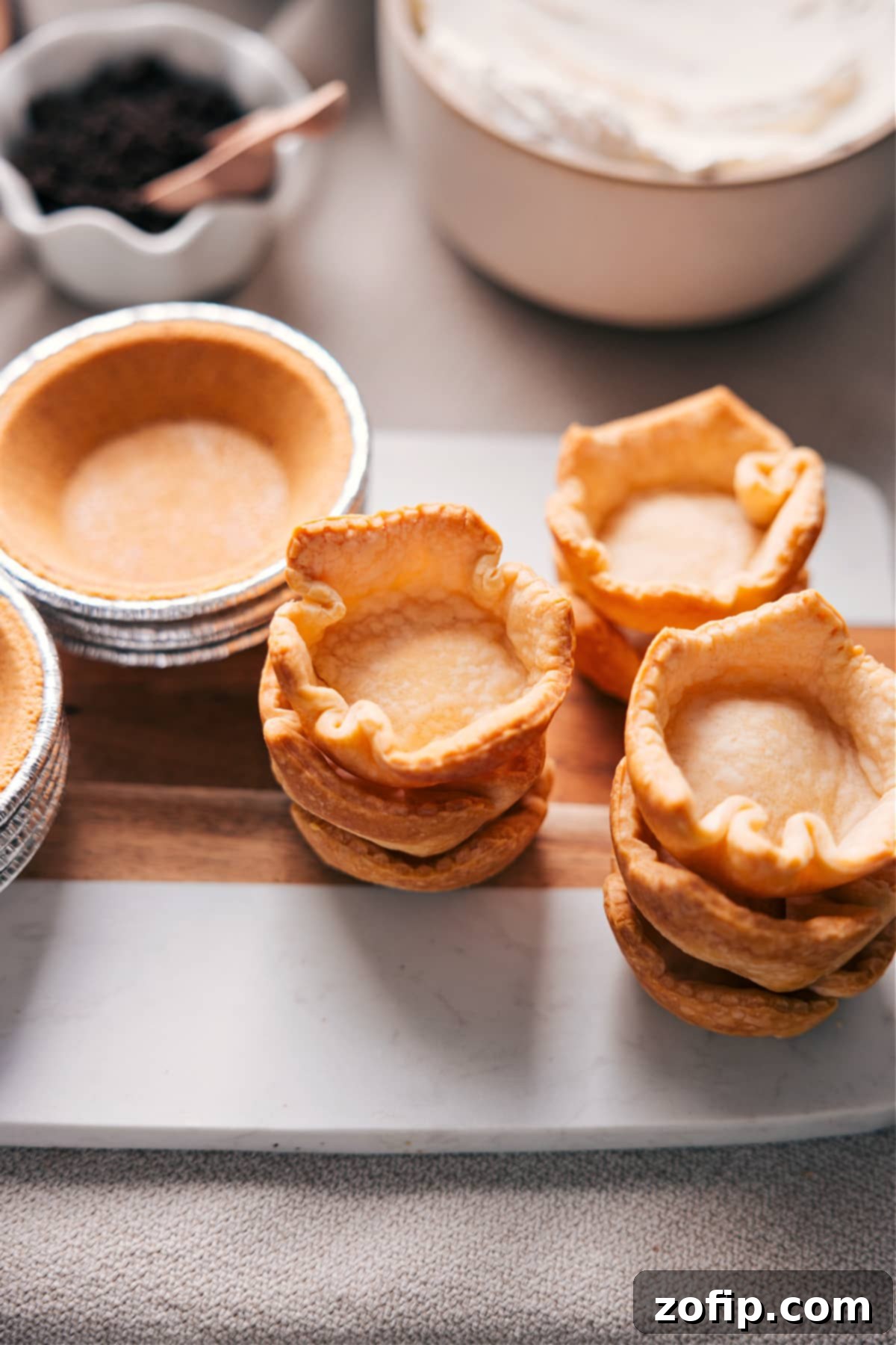 Crust options for your customizable pie A diverse assortment of mini pie crust options is showcased, including both beautifully baked homemade crusts and convenient store-bought varieties, illustrating the flexibility and ease of creating a customizable pie experience for a Dessert Pie Bar.