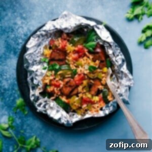 Close-up of Tin Foil Jambalaya ingredients ready to be mixed, including cooked andouille sausage, rice, and vegetables