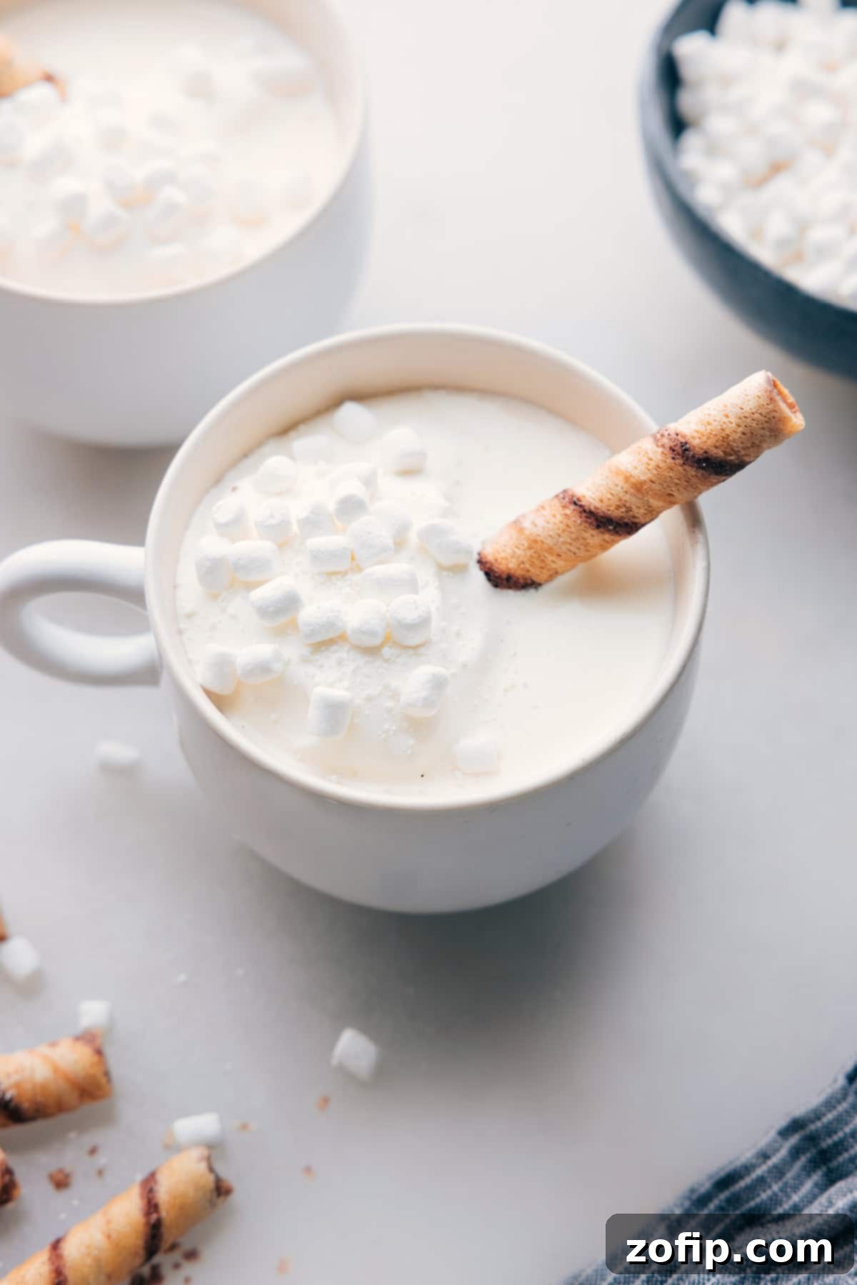 The finished White Hot Chocolate beverage in a mug, topped with mini marshmallows, a delicious and beautiful drink ready for enjoyment on a cold day.