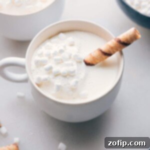 The finished white hot chocolate beverage in a mug, topped with mini marshmallows, a delicious and beautiful drink ready for enjoyment on a cold day.