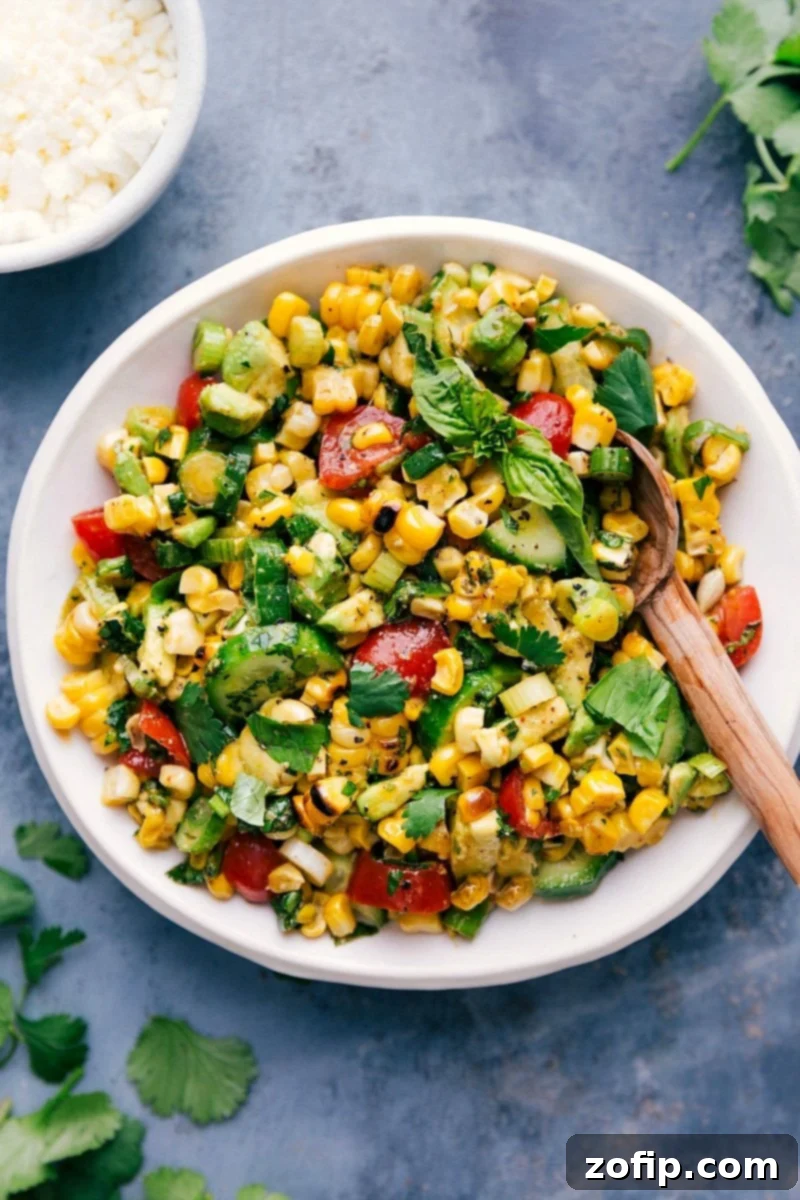 Bright and Tasty Corn Salad Ready to Serve Fresh corn salad in a bowl with a serving spoon.