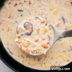 Velvety Artichoke Soup 3 A rich, creamy artichoke soup in a bowl, with a ladle, ready for serving.