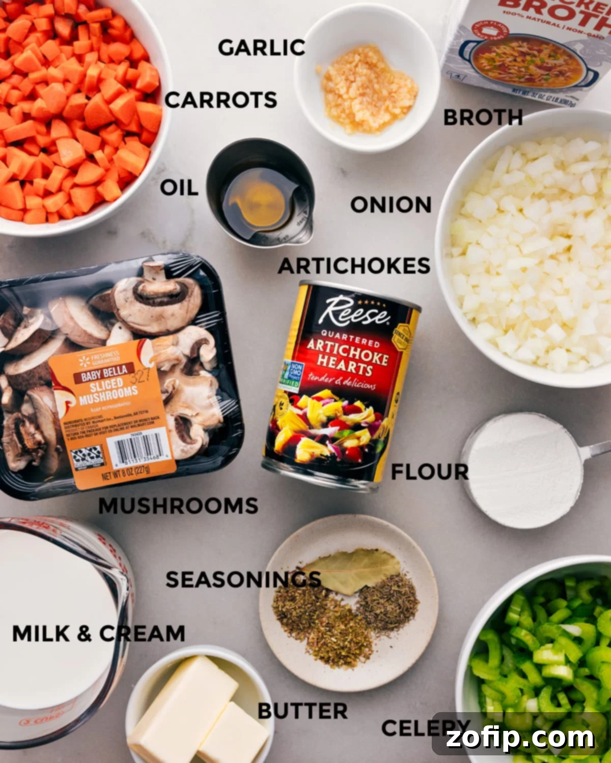 Ingredients for Rich and Creamy Artichoke Soup Recipe with Mushrooms and More A vibrant selection of fresh ingredients laid out for creamy artichoke soup, including whole artichokes, various mushrooms, onions, carrots, celery, butter, milk, and cream, emphasizing the recipe's wholesome components.