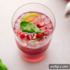 Big glass of Christmas Punch with fresh mint and limes in it.