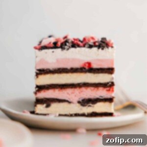 Peppermint Ice Cream Bars Recipe Image A perfectly portioned slice of these 3-ingredient Peppermint Ice Cream Bars, showing off its beautiful layers of ice cream sandwich, peppermint ice cream, and whipped topping, ideal for holiday dessert tables.