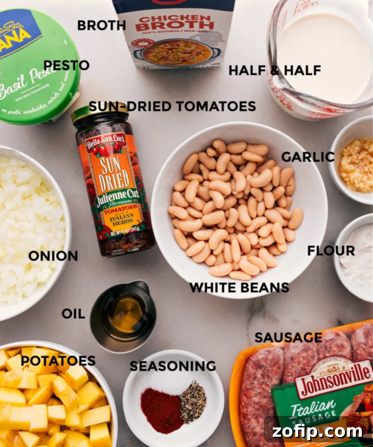 A vibrant collection of neatly prepped ingredients for Tuscan Sausage and Potato Soup, showcasing fresh white beans, finely chopped yellow onions, fragrant garlic, an array of seasonings, and other essentials, all ready for cooking.