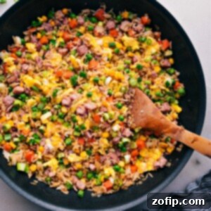 Ham Fried Rice 2 A vibrant bowl of Ham Fried Rice, generously garnished and ready to be enjoyed.