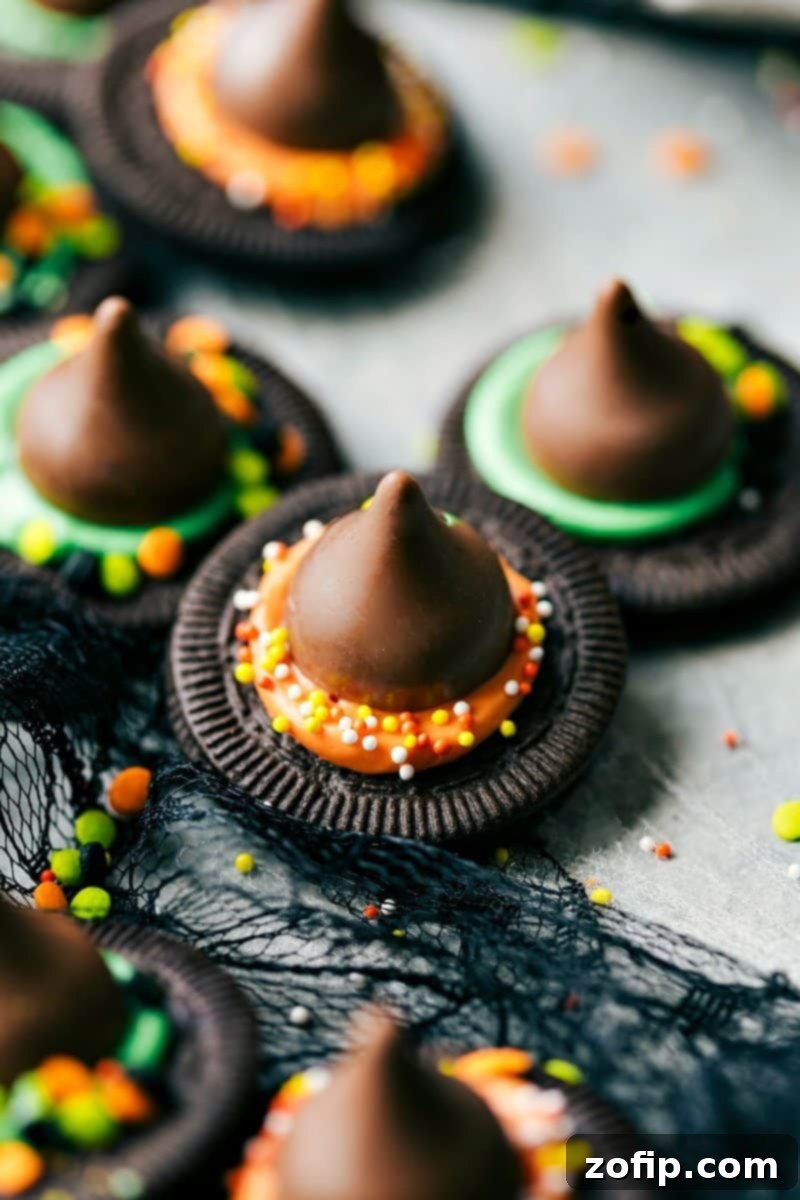 A vibrant Halloween platter featuring an assortment of easy no-bake treats, including chocolate witch hats on Oreo thins, perfect for a spooky party.