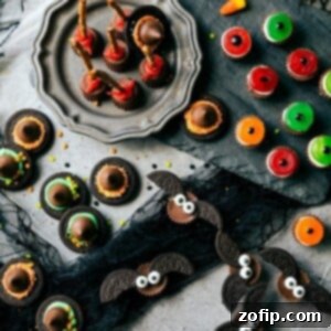 A vibrant Halloween platter featuring an assortment of easy no-bake treats, including chocolate witch hats on Oreo thins, perfect for a spooky party.