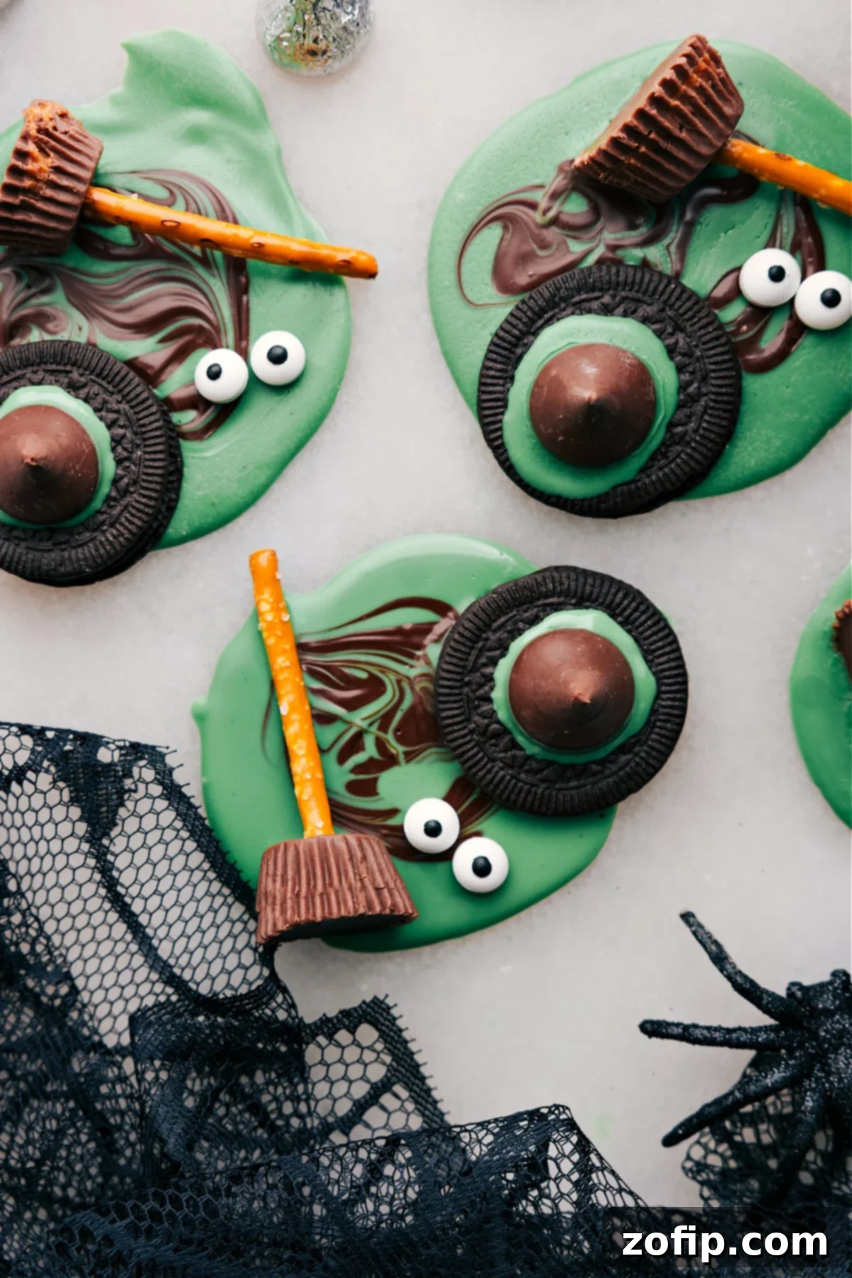 A top-down view of all four easy Halloween treats: Monster Eyeballs, Witch's Hats, Witch's Brooms, and Bat Bites, beautifully arranged on a dark platter with fall leaves.